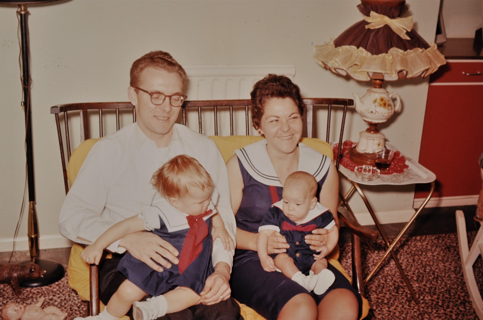 Dale as a baby held by his adoptive mother Joyce, with adoptive father Lewis holding his sister Laura, all in matching sailor outfits in England