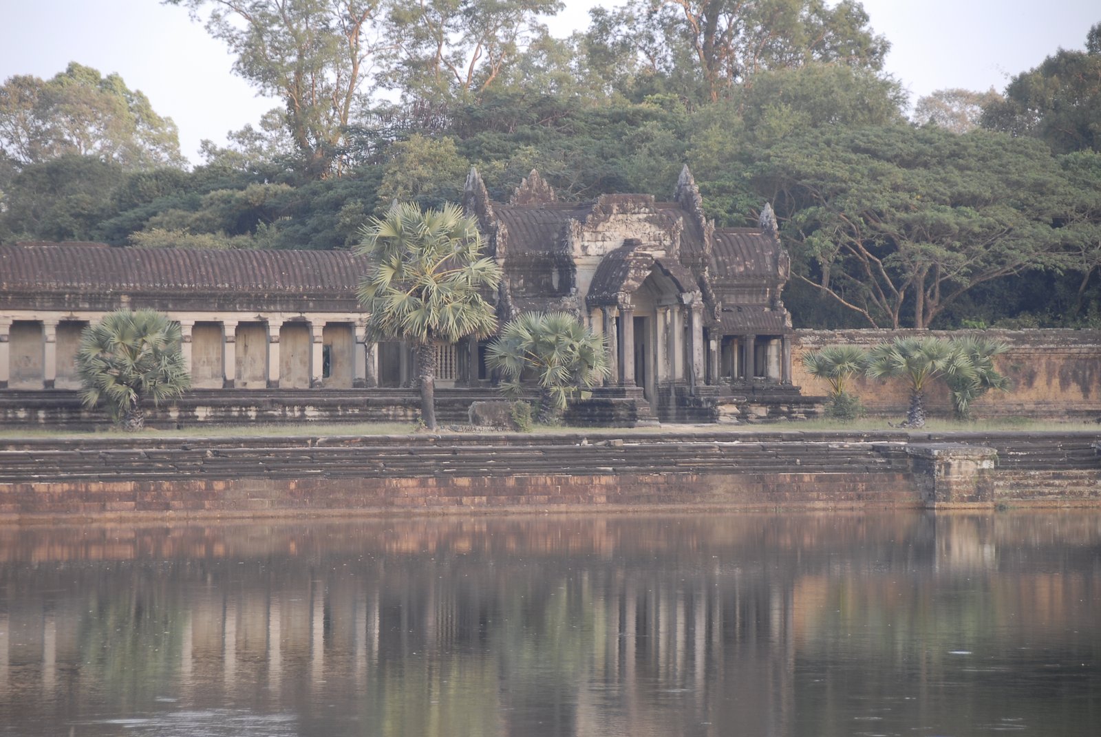 Ancient temple gate reflected in the water at Angkor Wat, Cambodia
